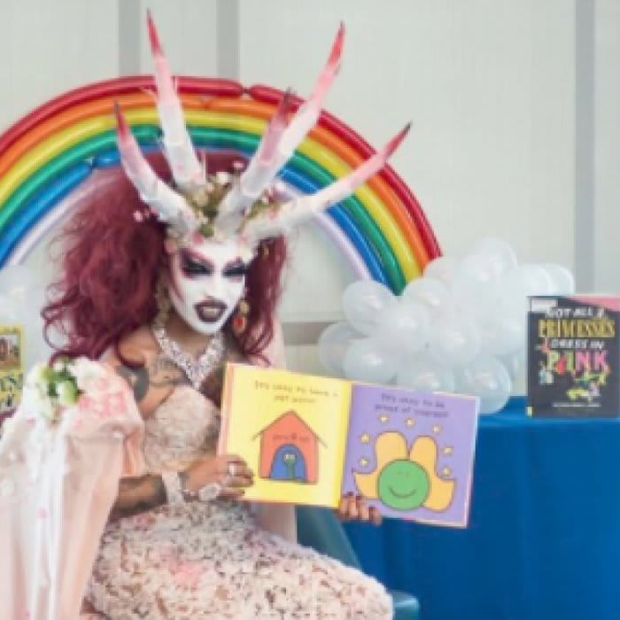 Photo of drag queen with horns reading to kids at Michelle Obama Neighborhood Library goes viral