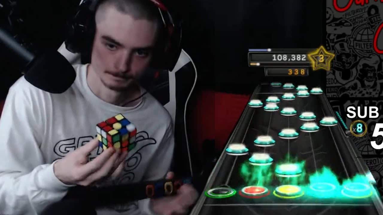 Solving a Rubik’s cube one handed, while the other hand 100 percents a song on guitar hero