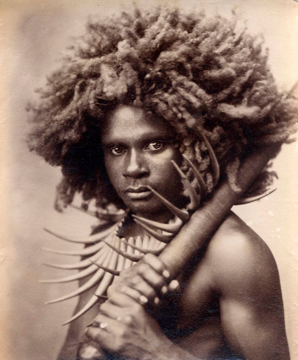 Fijian warrior wearing the wasekaseka split sperm whale’s tooth necklace, indicating high ranking status. circa 1880