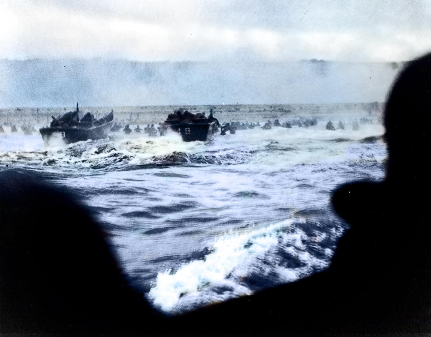 [Colorized] The Storming of Omaha Beach taken from a rare glimpse on one of the LCVPs depicts the troops pushing out of the wave. Troops taking heavy fire as soon as the doors drop can be seen jumping over the sides. June 6th, 1944.