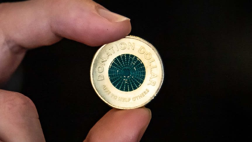 Royal Australian Mint releases 'donation dollar' coin designed to be given to charitable cause