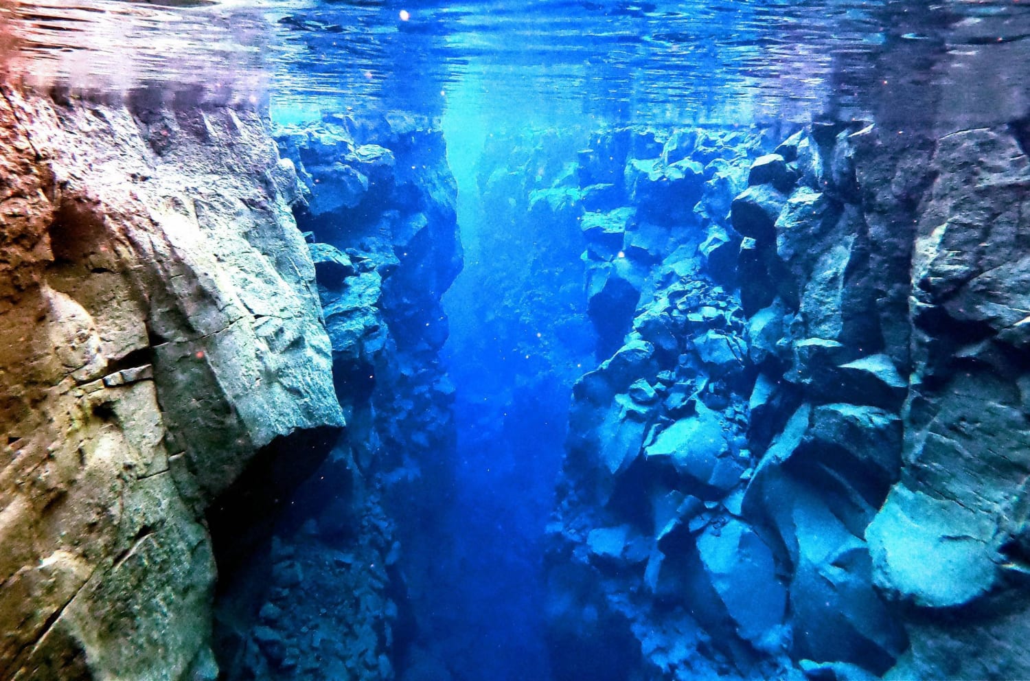 “The Silfra Rift” in Iceland sits between the North American and Eurasian tectonic plates. It has crystal clear water, and you can snorkel and dive between the two continents.