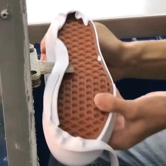 Using a hotknife to cut away excess foxing tape from a pair of Vans. (White Edition)