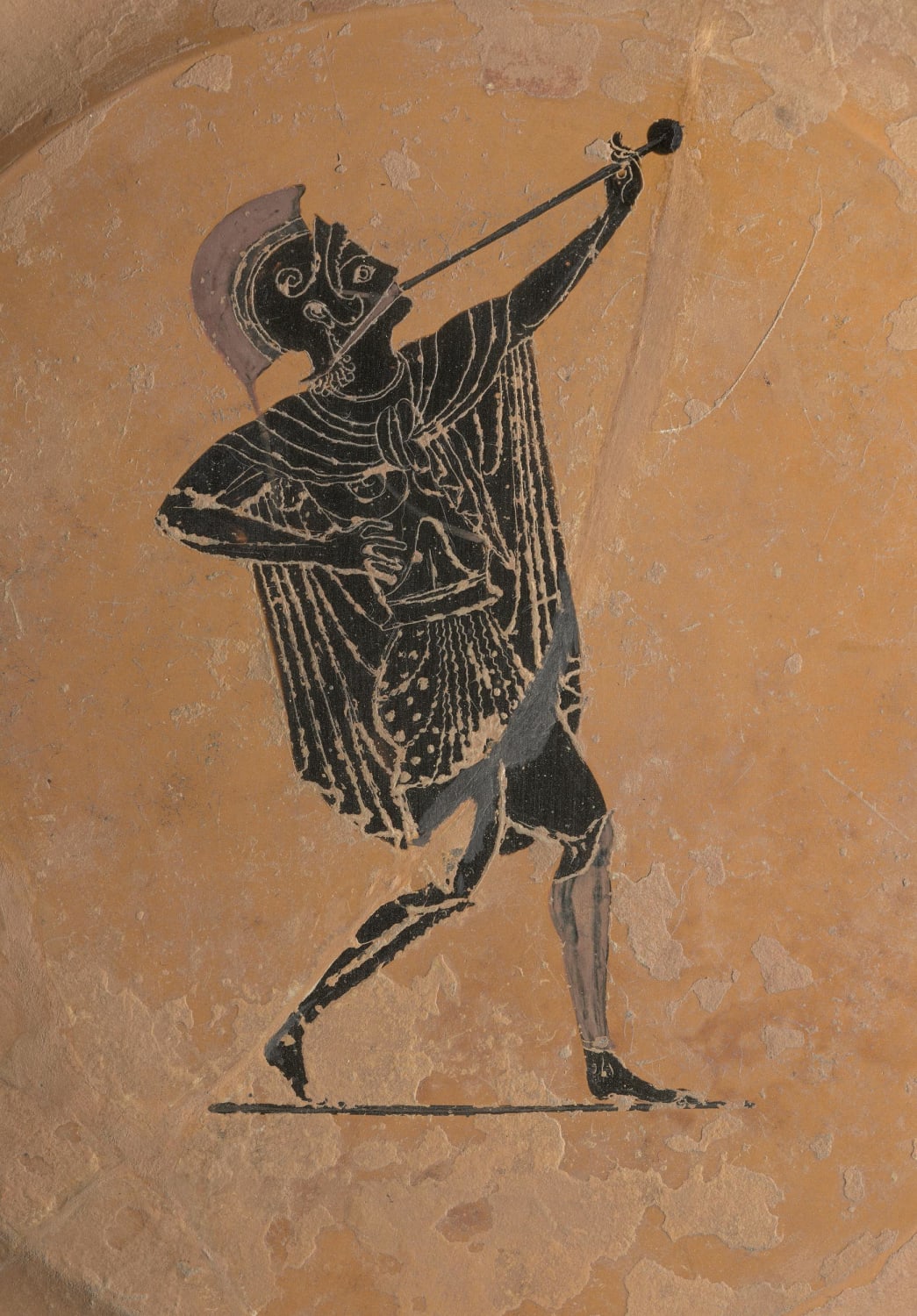 Black-figured pinax (plate) showing a soldier blowing a trumpet (salpinx). Greek made in Athens around 520 BC. Attributed to the painter Psiax.