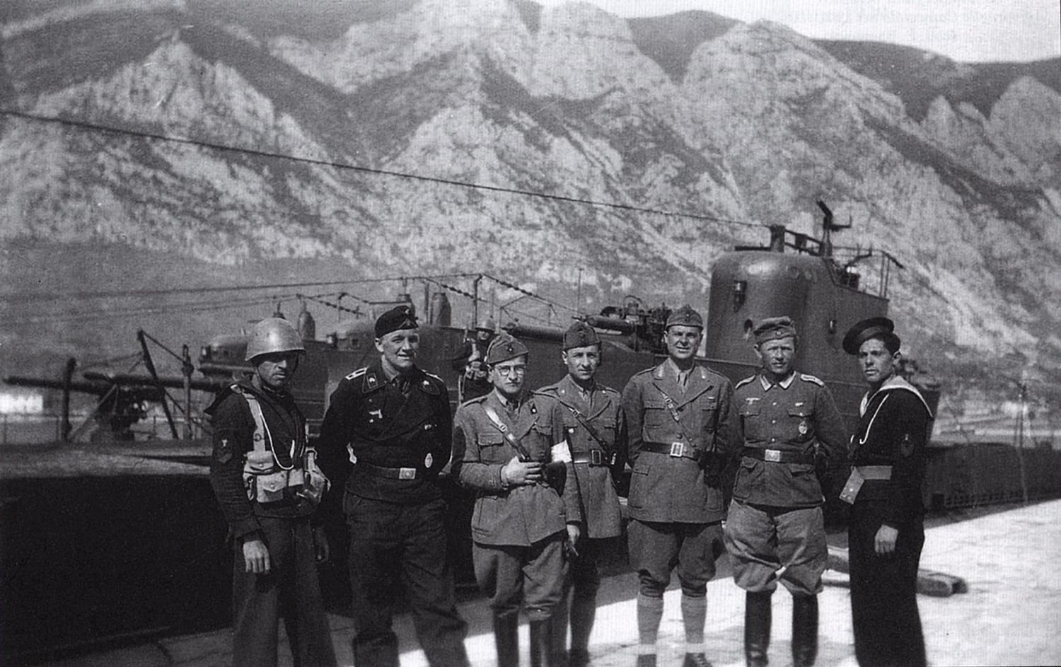 Italian and German soldiers and sailors standing in front of captured Yugoslav submarines (Hrabri in the foreground), Kotor, April 1941