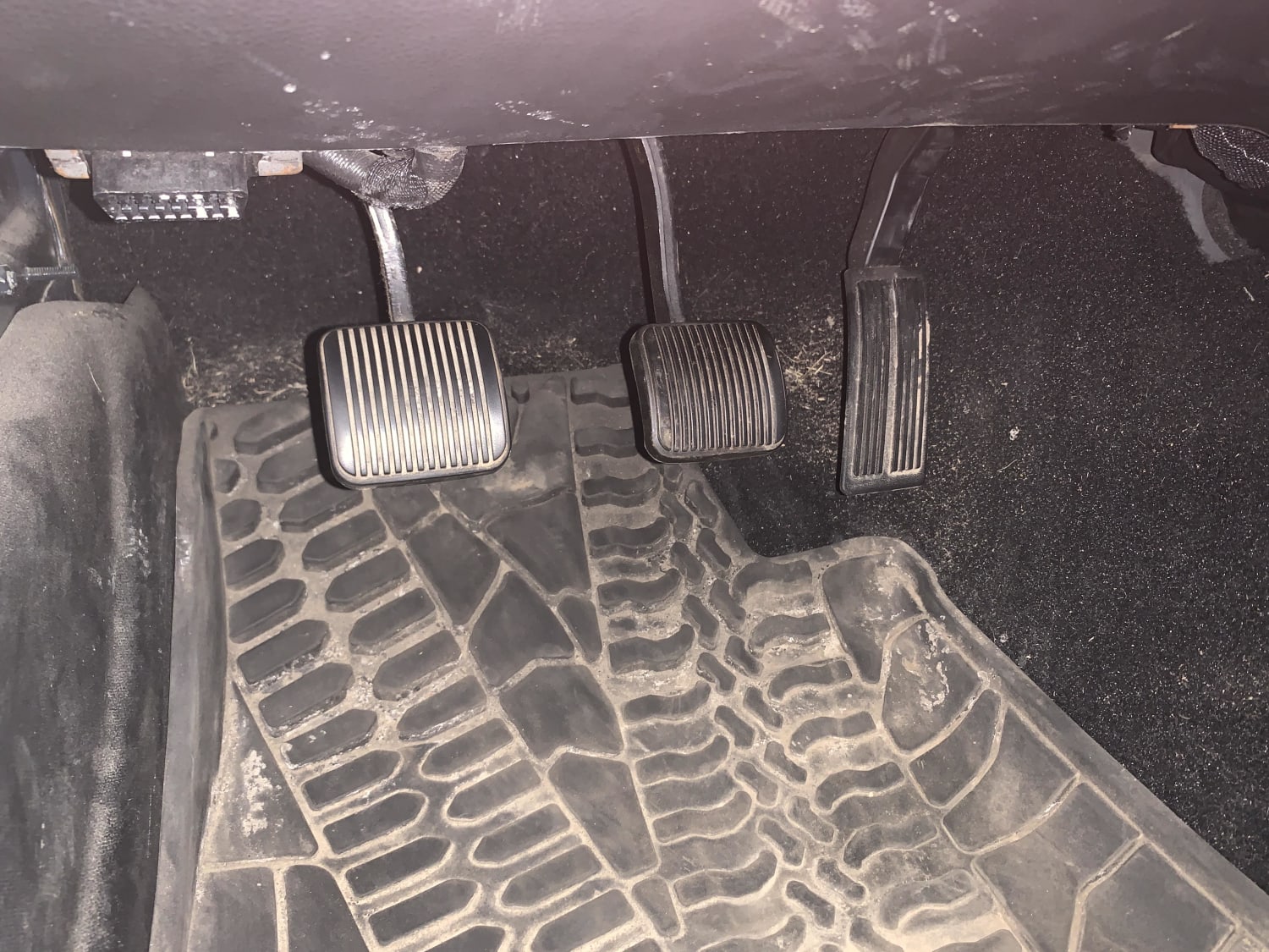 Jeeps floor mats excluding under the accelerator to prevent the pedal from getting stuck on the mat.