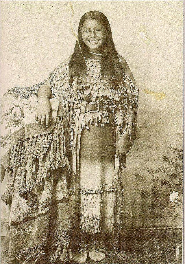 Native American girl smiling for the camera in 1894