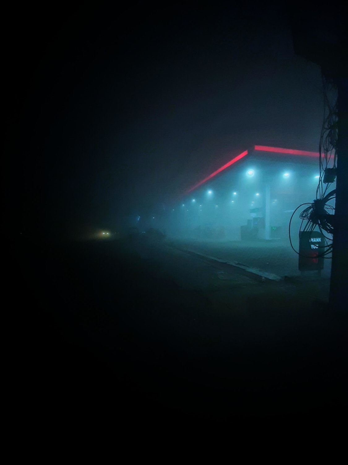 ITAP of a secluded gas station on a foggy night