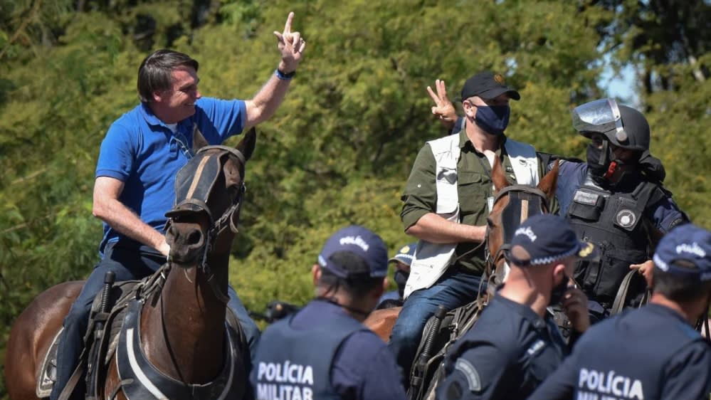 Bolsonaro saddles up to join rally against Brazil's top court