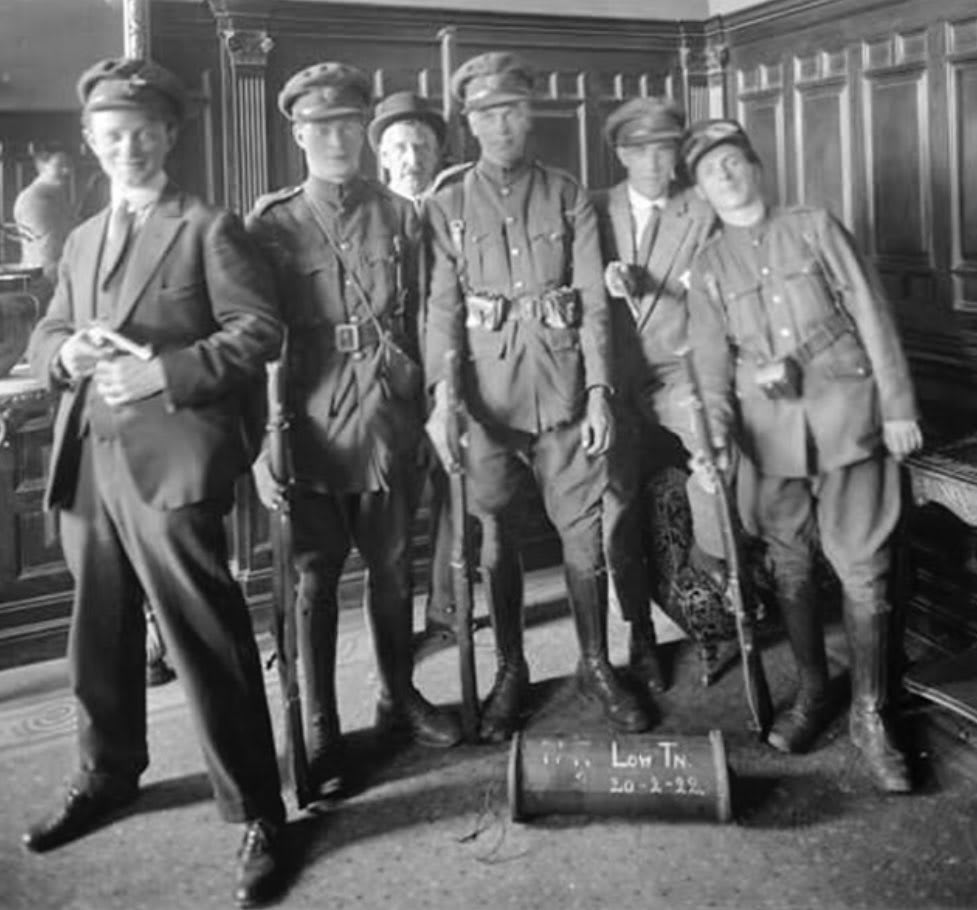 Irish Free State soldiers pose with a mine in the Granville Hotel, Wateford. Just two days ago, Waterford, which was held by IRA rebels, was recaptured.