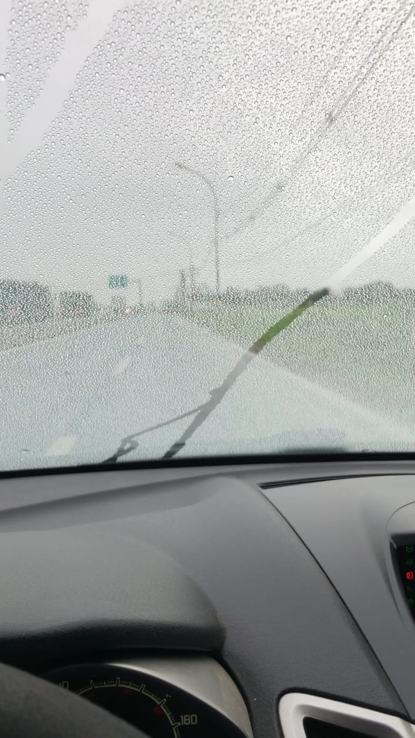 Windshield with hydrophobic coating. Once you get enough speed, you don’t even need the wiper.