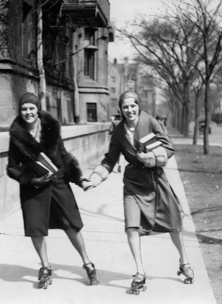 Two students roller skate to class at the University of Chicago, 1930