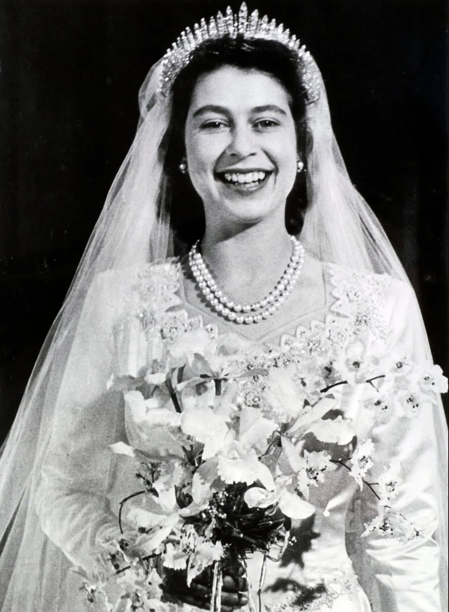 In honor of Queen Elizabeth II’s passing, we're highlighting her 1947 wedding gown designed by Norman Hartnell, which wowed the world with all of its details, and aimed to symbolize prosperity to England.