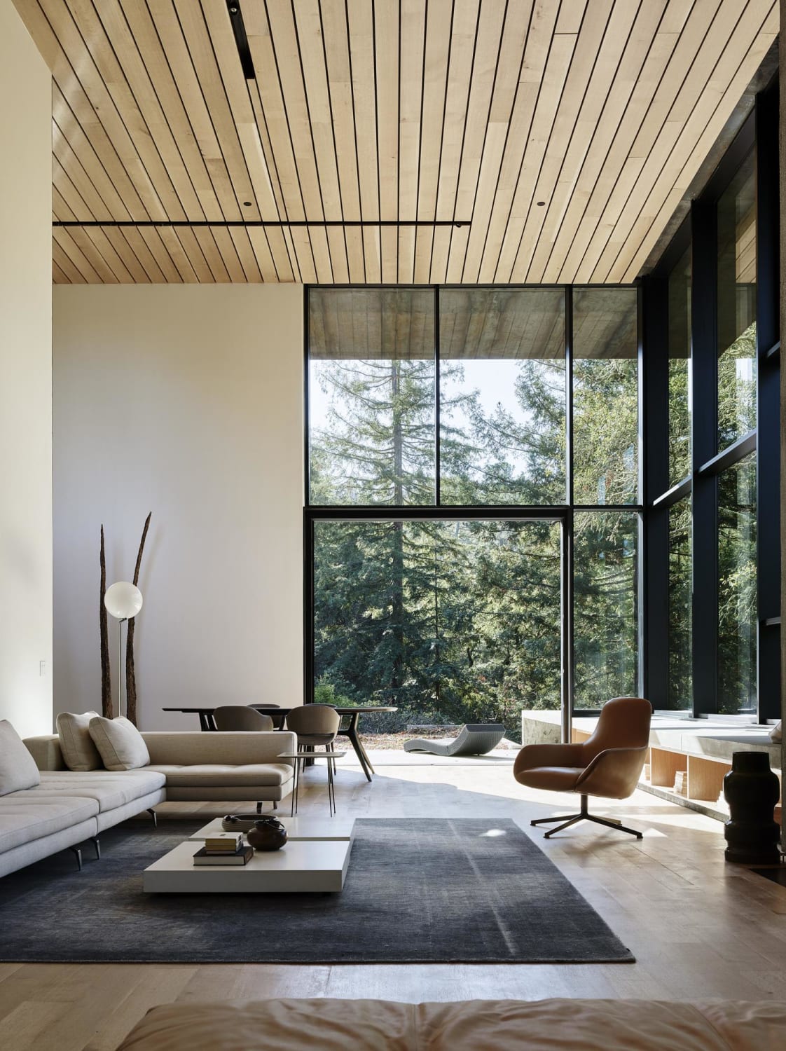 Double-height living area surrounded by oak trees in a sustainable house with net-zero energy performance, Orinda, California by Faulkner Architects (Photo: Joe Fletcher)