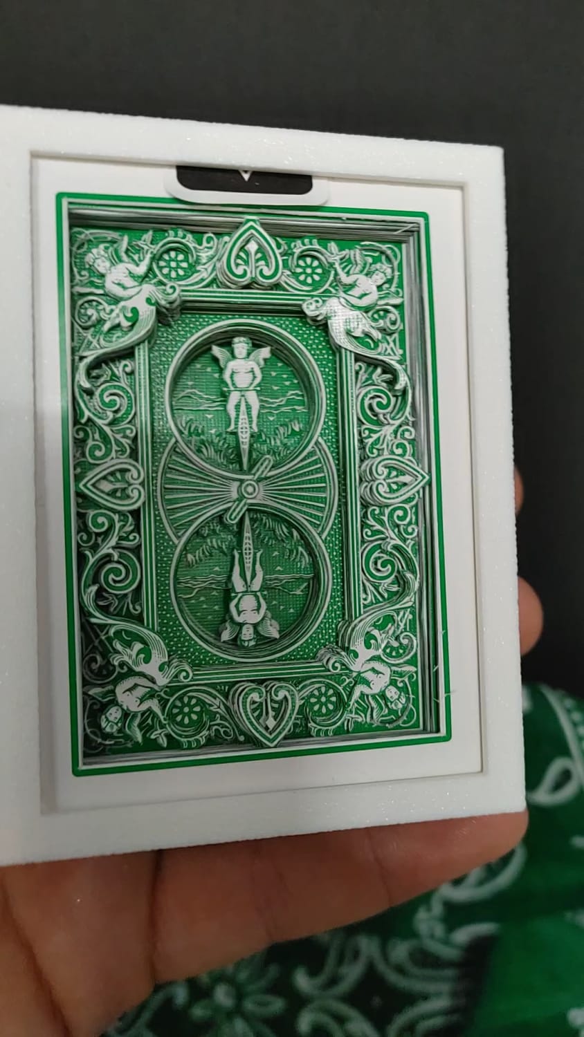 I cut bicycle playing cards into art with an xacto knife. This is the second time I have cut this color and it is by far my most detailed piece yet.