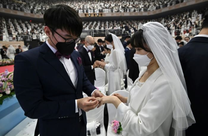 In sickness and in health: mass wedding defies virus fears
