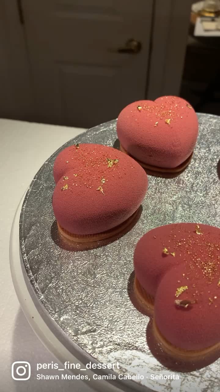 Chocolate mousse cakes with strawberry filling and chocolate sponge. Decorated with chocolate velvet spray and 24K edible gold leaves. Love at first bite!