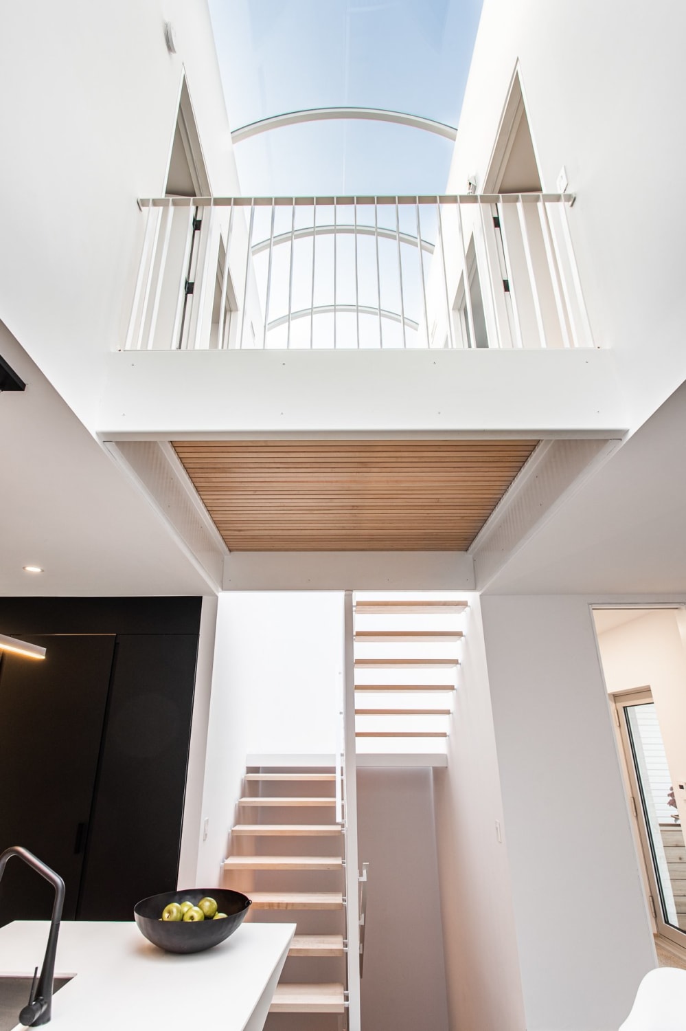 Staircase leading up to a skylight in a terraced house, Montreal, Canada by Fugere Architecture