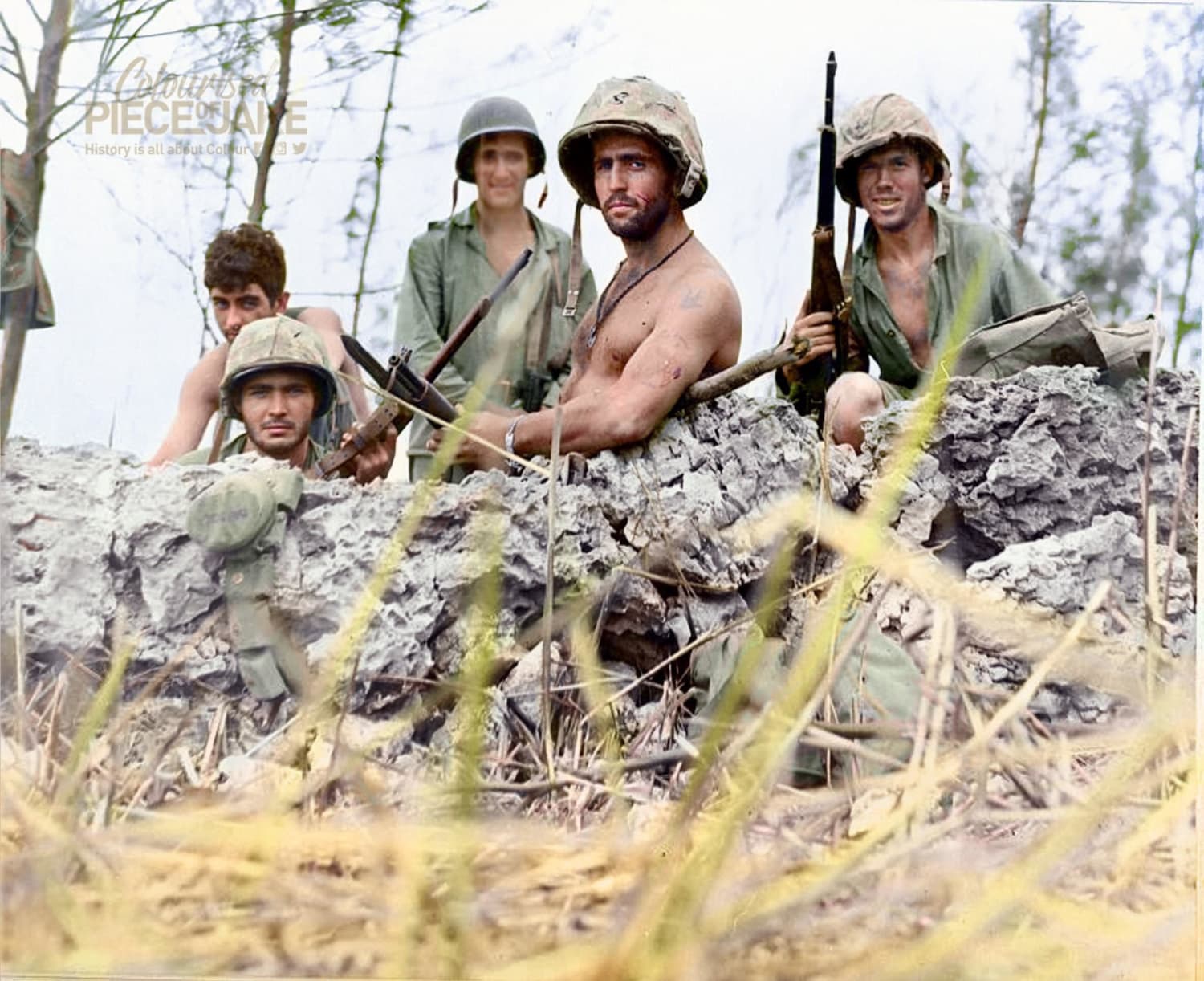 U.S. Marines pose in foxhole near front lines during the Invasion of Saipan, Mariana Islands, July 1st 1944. (Photographed by USS Indianapolis photographer, National Archives.)