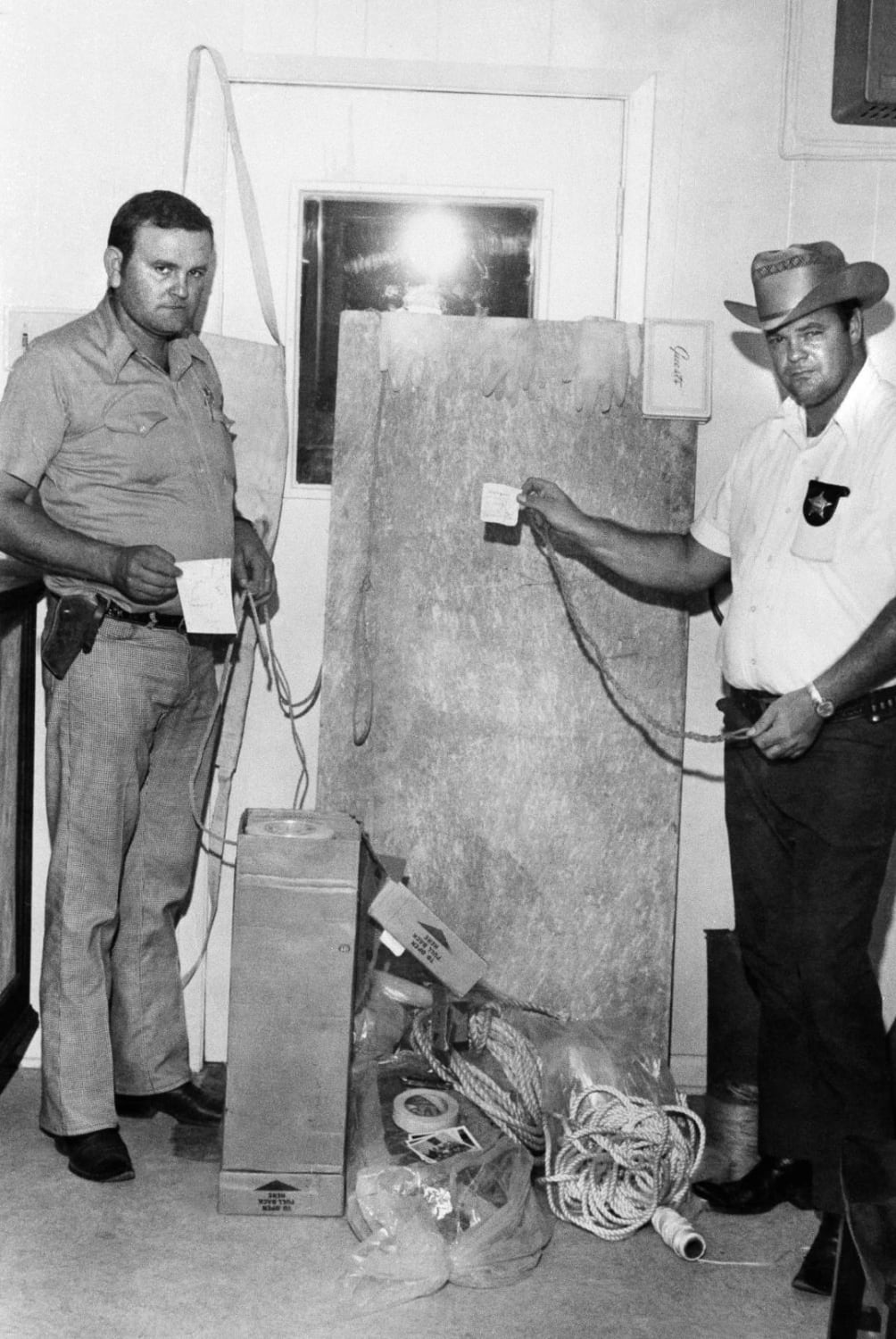 Police stand next to several tools used for torture and murder belonging to Dean Corll. Corll would often keep his victims alive for several days while he raped and tortured them before he was shot dead by his accomplice in 1973. He is known to have murdered at least 28 people all aged from 13-20.