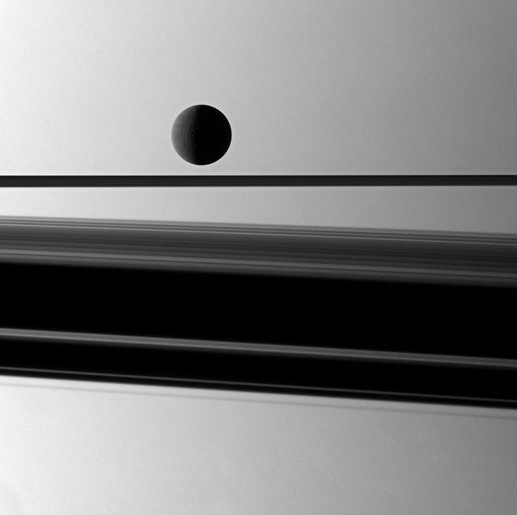 Cassini catching a glimpse of the ice moon Rhea through Saturn’s rings