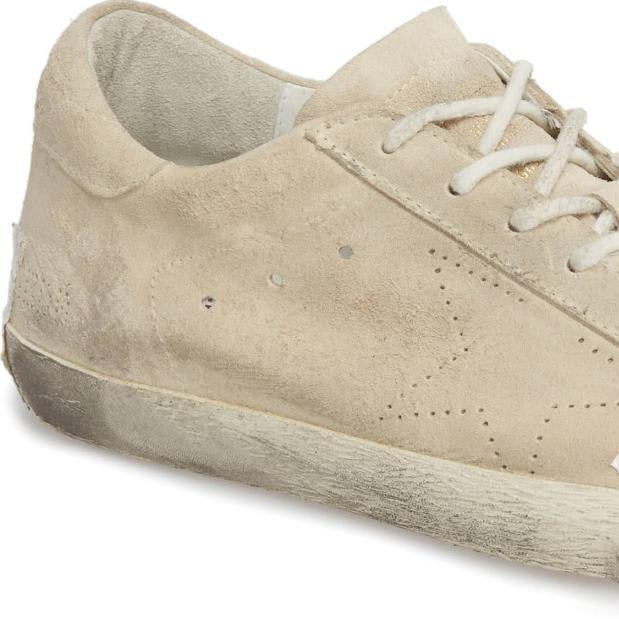These grungy, taped-up designer sneakers sell for $530. Critics say they glorify poverty