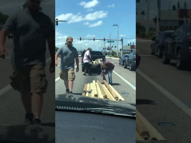 Strangers Help Old Man Load Timber Fallen on the Road Into his Pickup Truck - 1198316