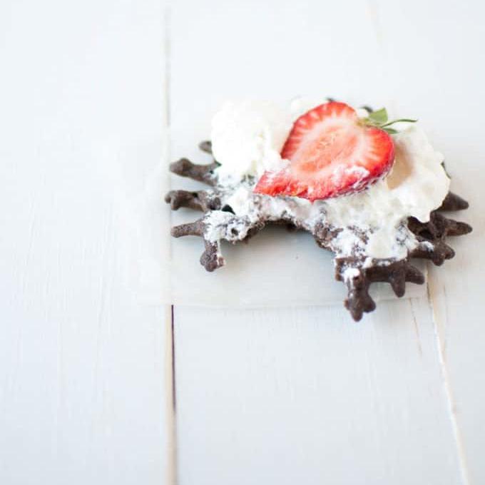 healthy whole grain mini chocolate waffles with cream and berries