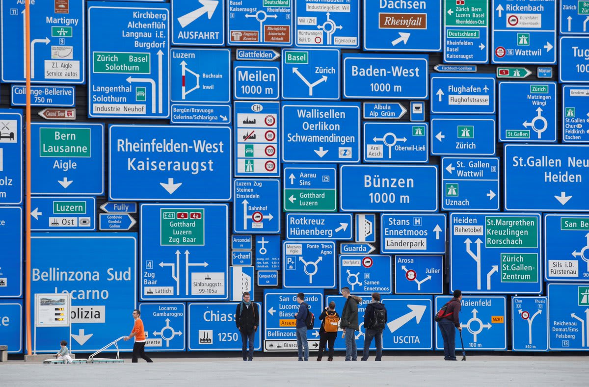 Visitors stand in front of a wall covered with road signs at the Verkehrshaus Luzern (Swiss Museum of Transport) in Luzern, Switzerland. Picture by REUTERS/Arnd Wiegmann