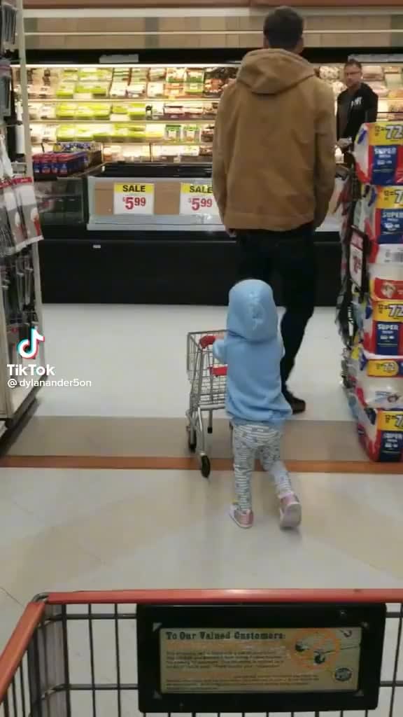 man helps kid with her shopping