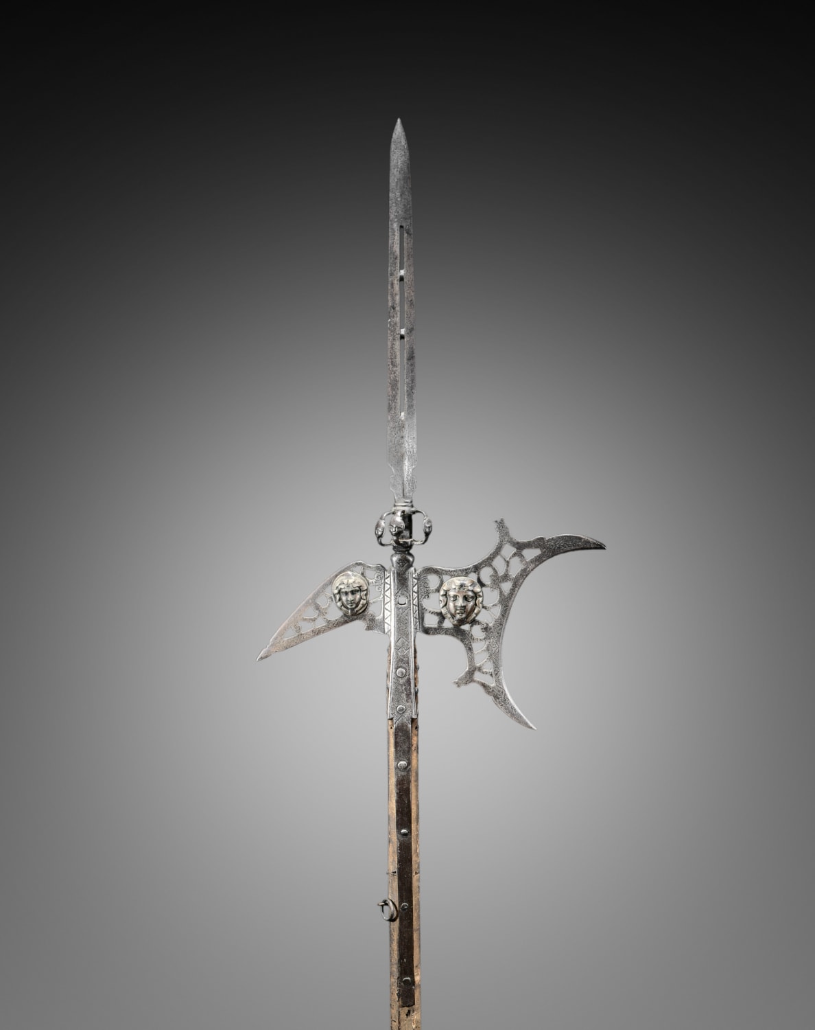 Halberd decorated with appliqué masks in brass, France, early 17th century