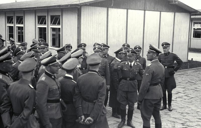 Heinrich Himmler leads a large group of SS officers during a visit to Mauthausen concentration camp, June 1941;