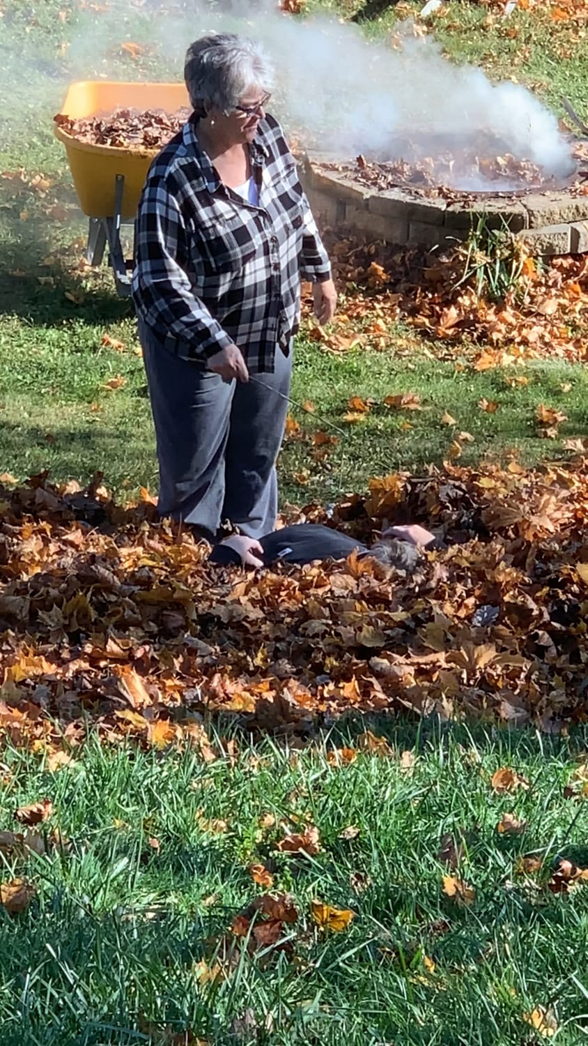 My silly parents playing in a leaf pile.