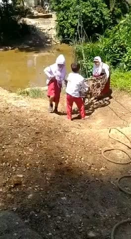 Schoolchildren in a remote Indonesian village have to go "Indiana Jones style" to cross a river to get to their School