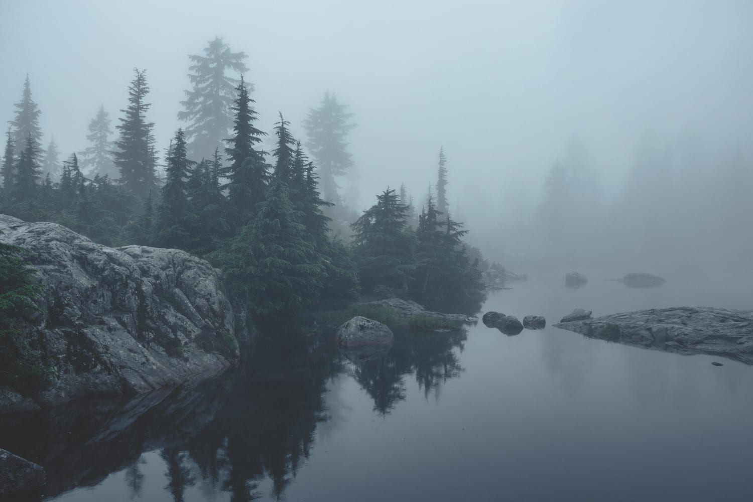 Fog on a mountain side lake - North Vancouver, BC. Canada