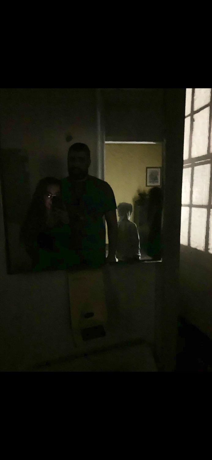 Me, my husband, and my little brother at the trans Allegheny lunatic asylum last year. It was only us on the tour and the guide was in the room with us. Look beside my little brother. (We were on the children’s ward)