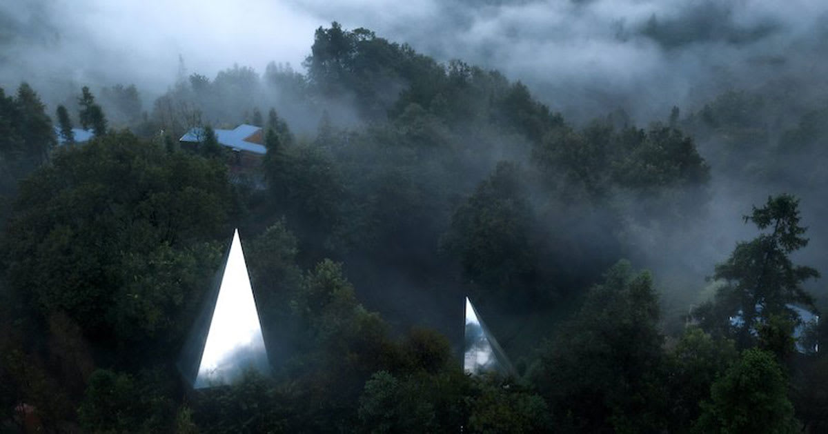 futuristic reflective cabins with pointy roofs emerge from dense forest in huzhou, china