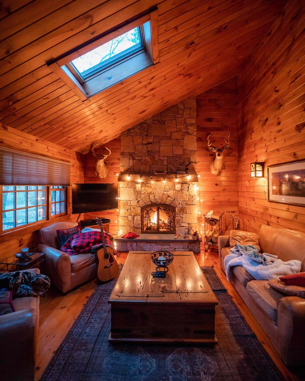 This cozy and rustic living room of a log cabin located in the Berkshire Mountains, Massachusetts