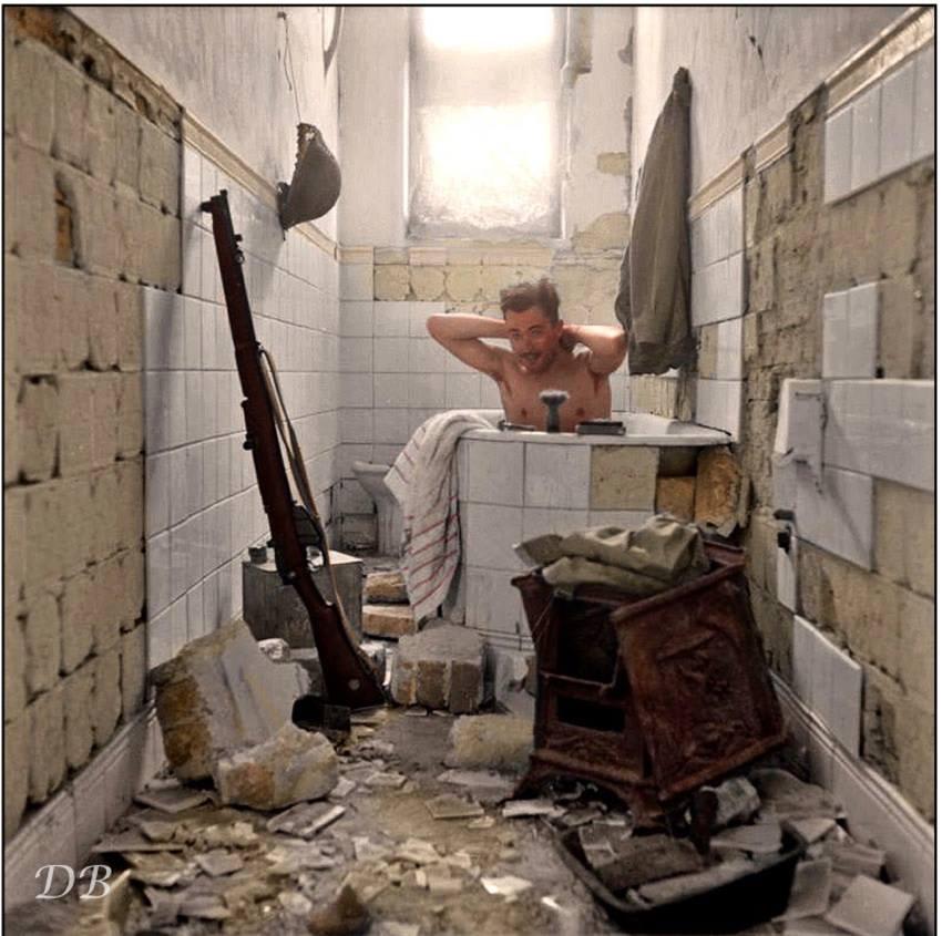 British soldier takes advantage of the opportunity to have a bath in the port city of Tobruk, Libya. 17 February 1942. [colorization]
