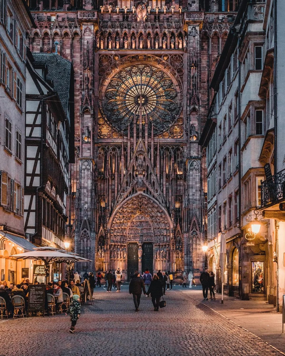 The massive Gothic facade of Strasbourg Cathedral, built between 1015 and 1439, seen from the Rue Mercière in the Grande Île island that lies at the historic center of Strasbourg, Grand Est, France.