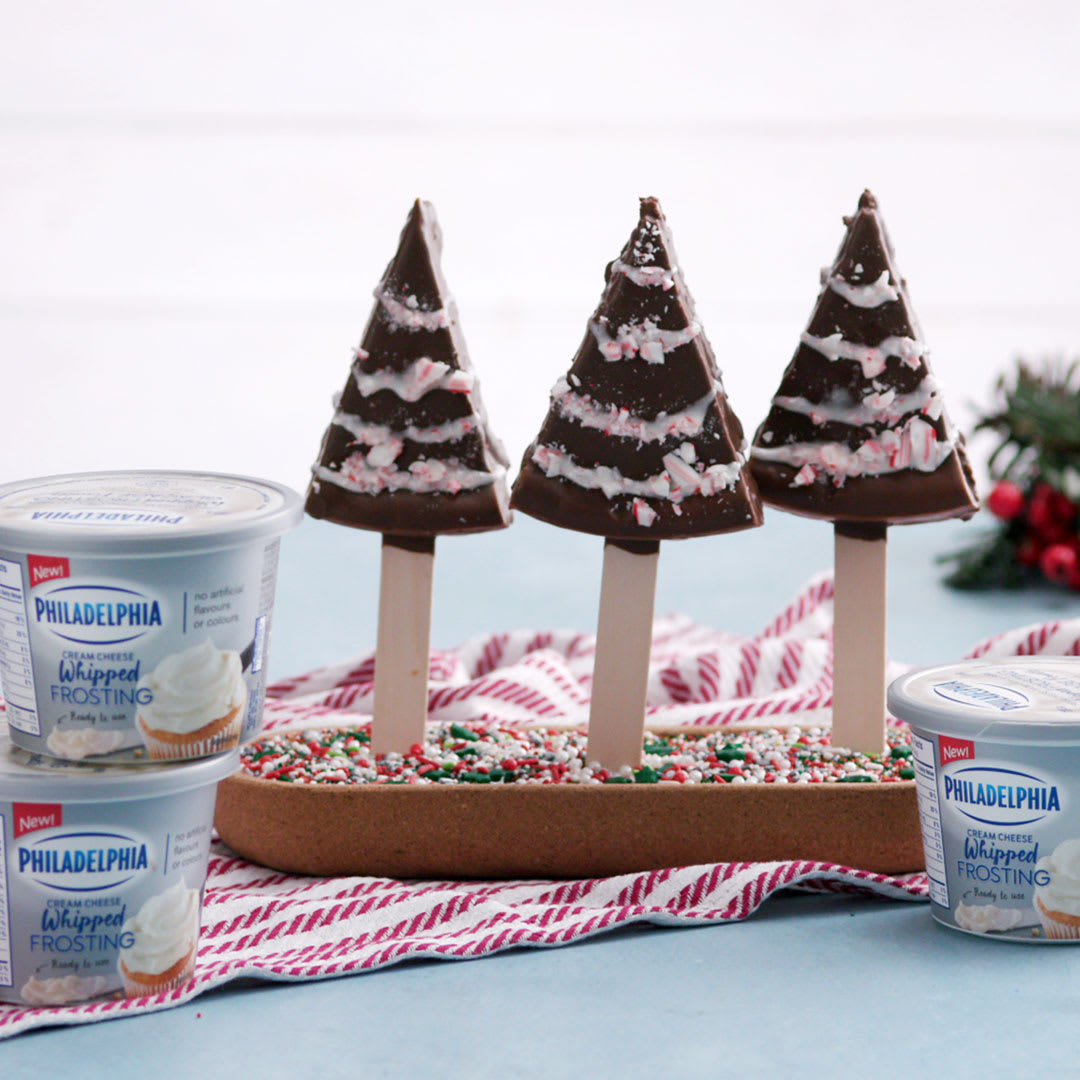 Holiday party tip: Have some fun with Philadelphia Cream Cheese Frosting and decorate a batch of peppermint cheesecake Christmas trees! PhillyFrosting sponsored by