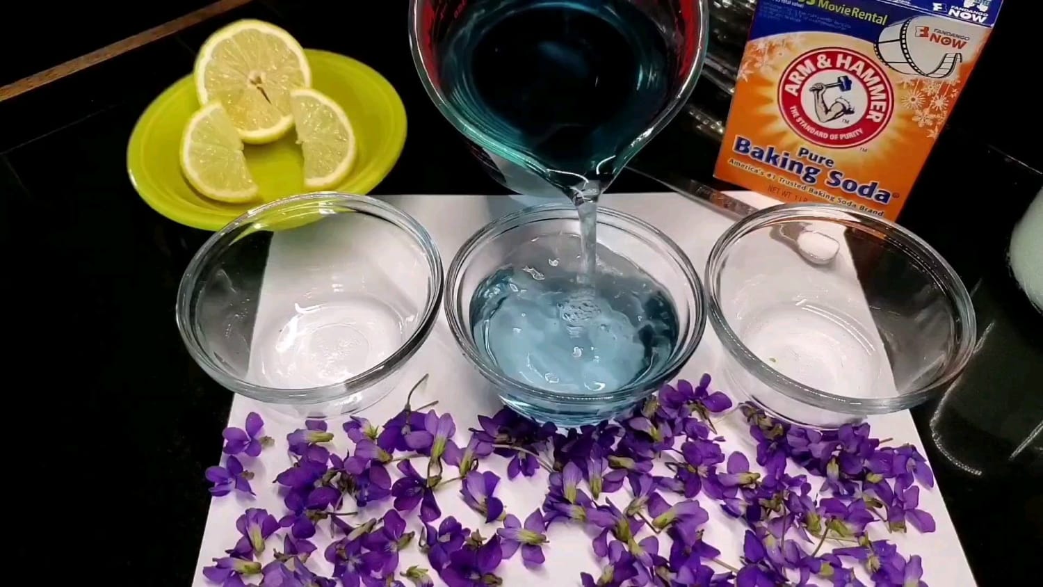 Many blue or purple flowers contain pigments known as anthocyanins. These compounds change color depending on the pH of the solution they are in. Here's a simple demonstration with some wild violets from my yard.