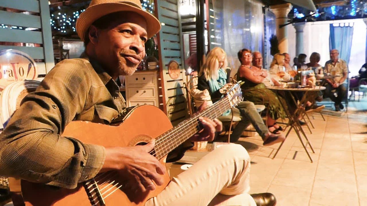 Incredible guitar master playing for a restaurant lobby