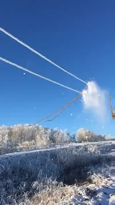 Scraping ice off power lines