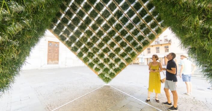 Geometric pavilion with an inverted living garden holds court in a public square in Annecy, France