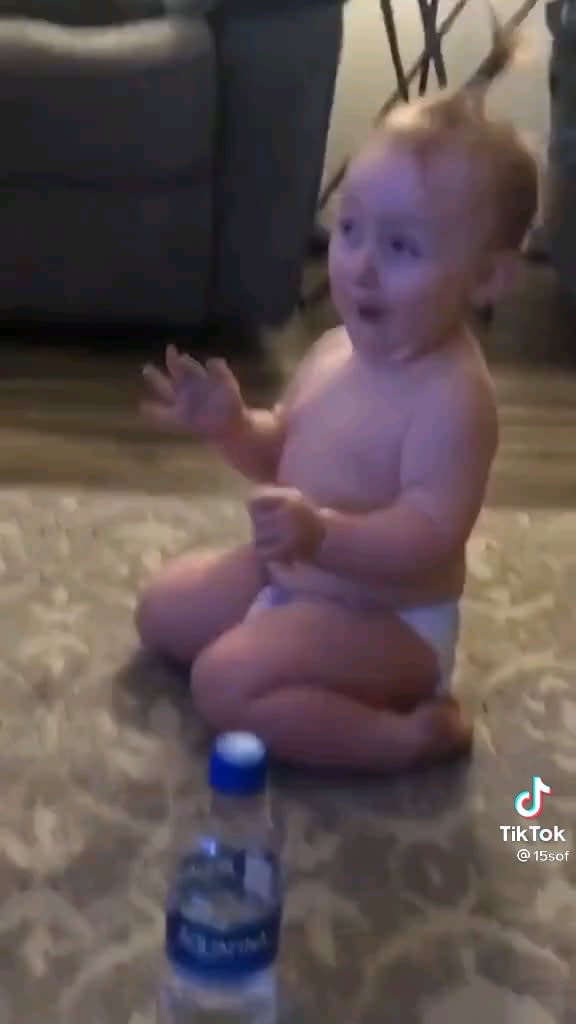 Baby flips a bottle...