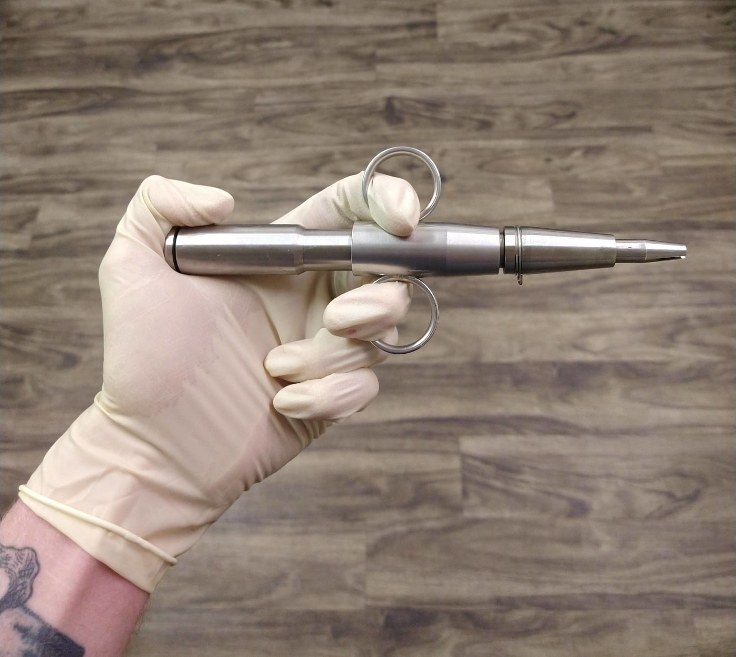 A needle injector, the preferred tool for sealing the mouth of a dead person.