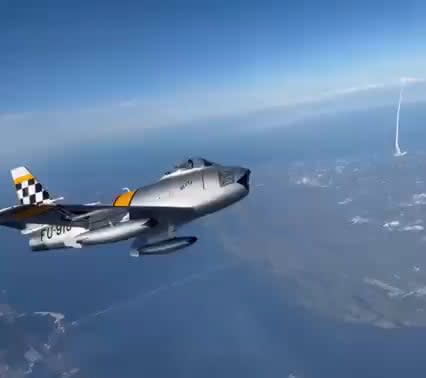 The Atlas-V rocket was launched from Cape Canaveral, FL today. An F-86 fighter jet flying by managed to capture the launch.