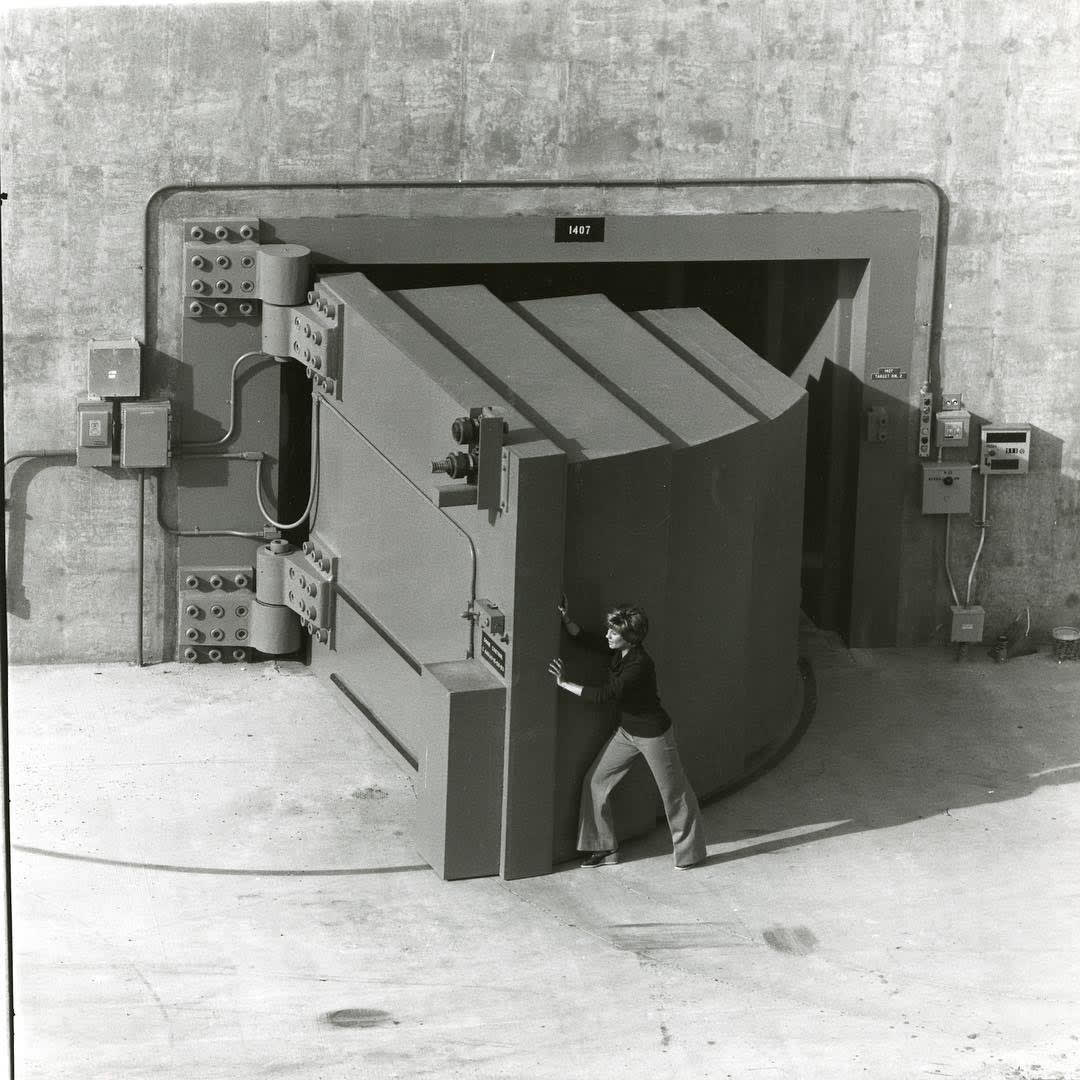 A door filled with concrete used as a shield against the world's most powerful continuous fusion neutron source, 1979. A special bearing in the hinge allowed one person to open or close the door.