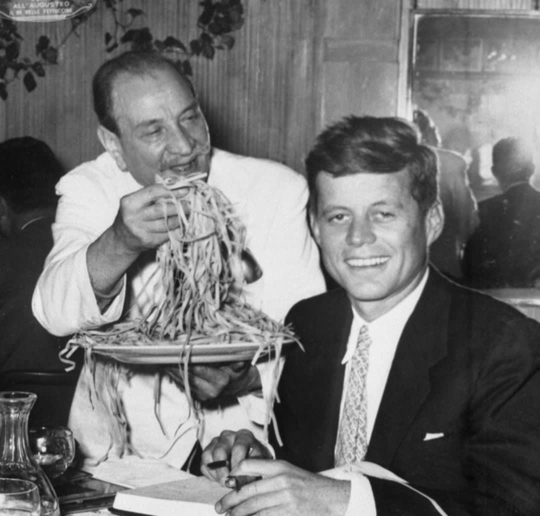 JFK eating at the World famous Alfredo's trattoria in Rome, Italy, summer of 1963.